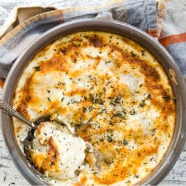 A baking dish full of Au Gratin potatoes.