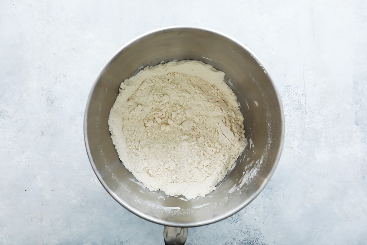 Dry ingredients in a silver mixing bowl for blueberry scones.
