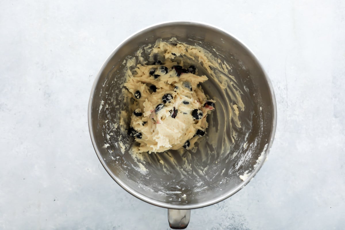 Blueberry scone dough in a silver mixing bowl.