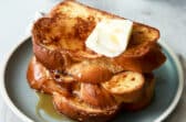 A plate of 3 slices of Challah French toast.