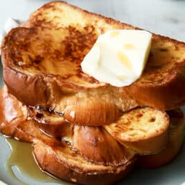 A plate of 3 slices of Challah French toast.
