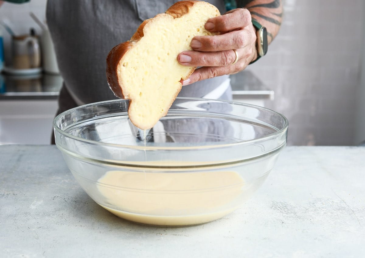 Dipping Challah in batter for French toast.