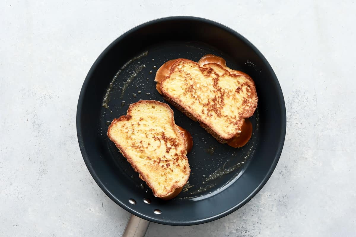 A skillet with Challah French toast browning in it.