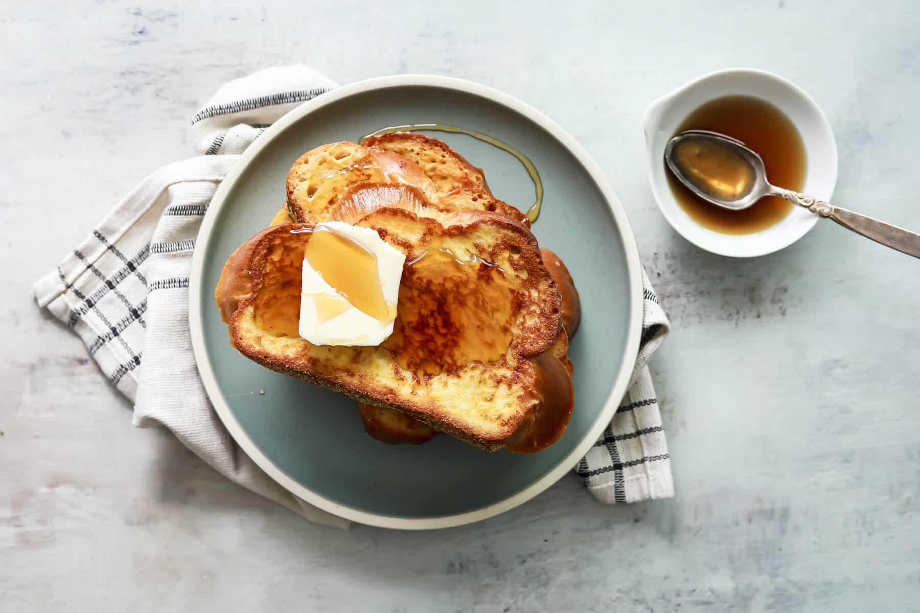 A plate of 3 slices of Challah French toast.