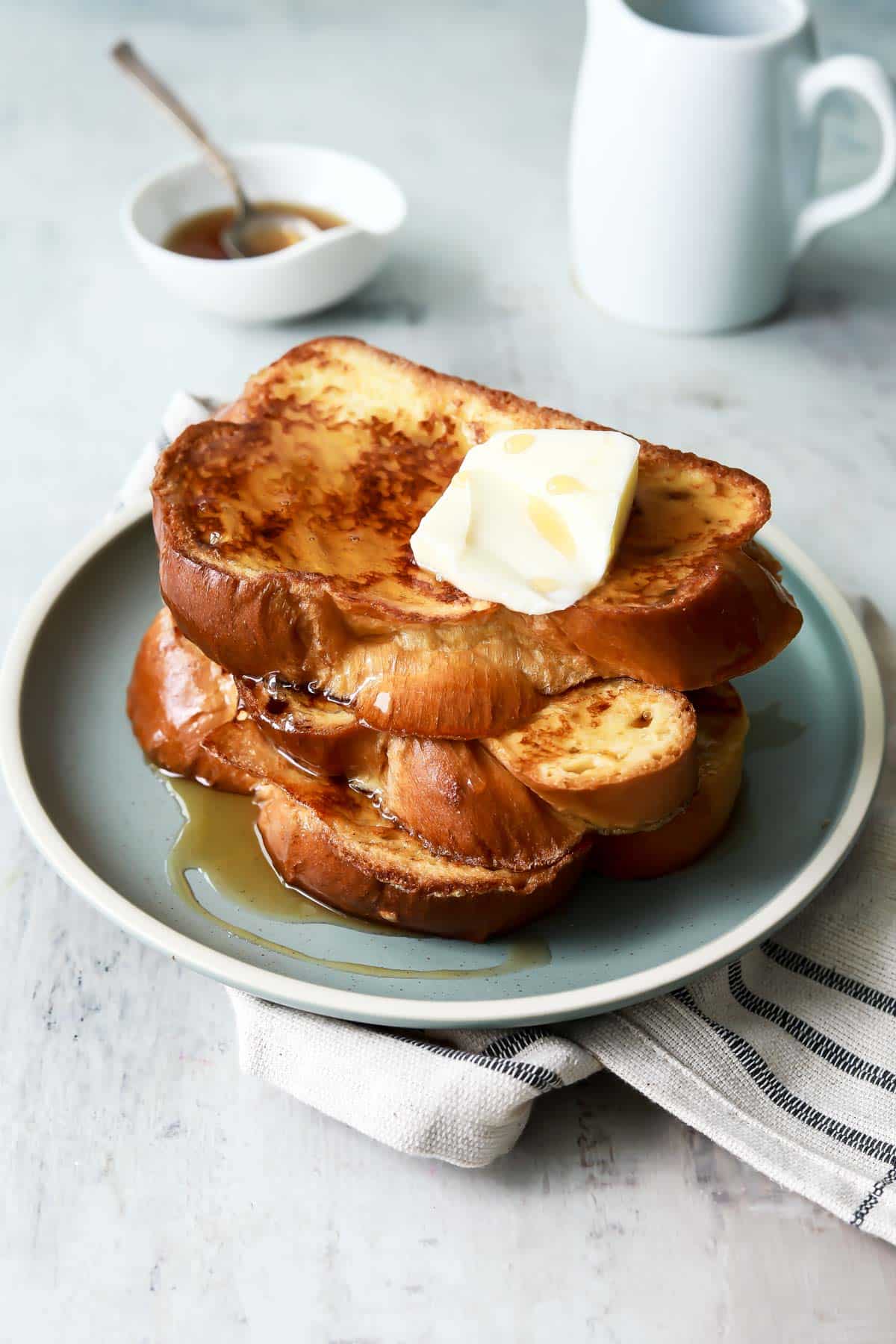 A plate of 3 slices of Challah French toast.