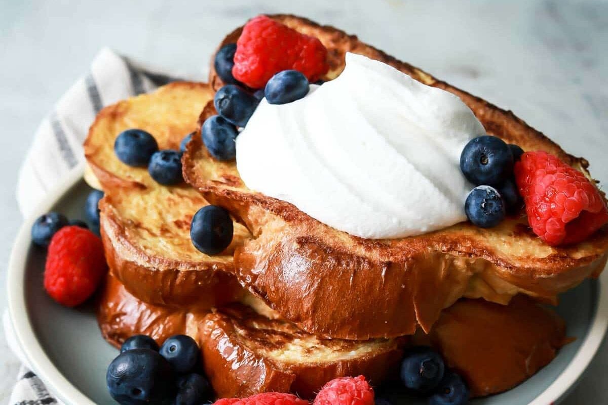 A plate of 3 slices of Challah French toast.
