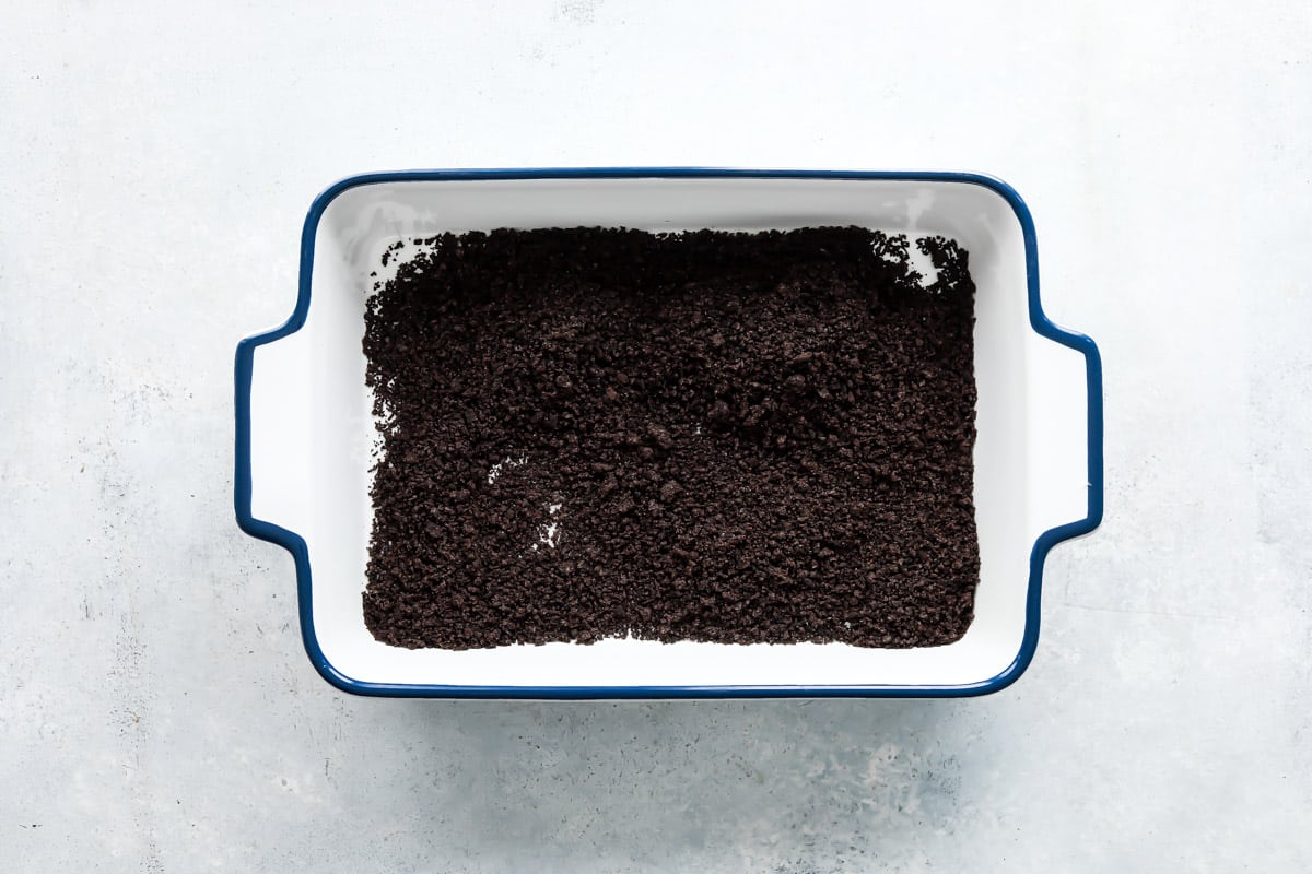 Crushed oreos in a baking dish.