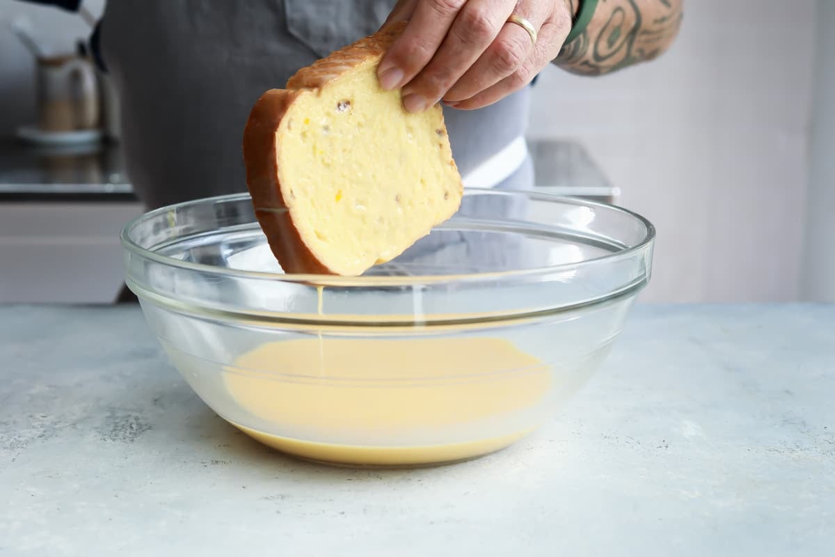 Dipping bread in batter for French toast.
