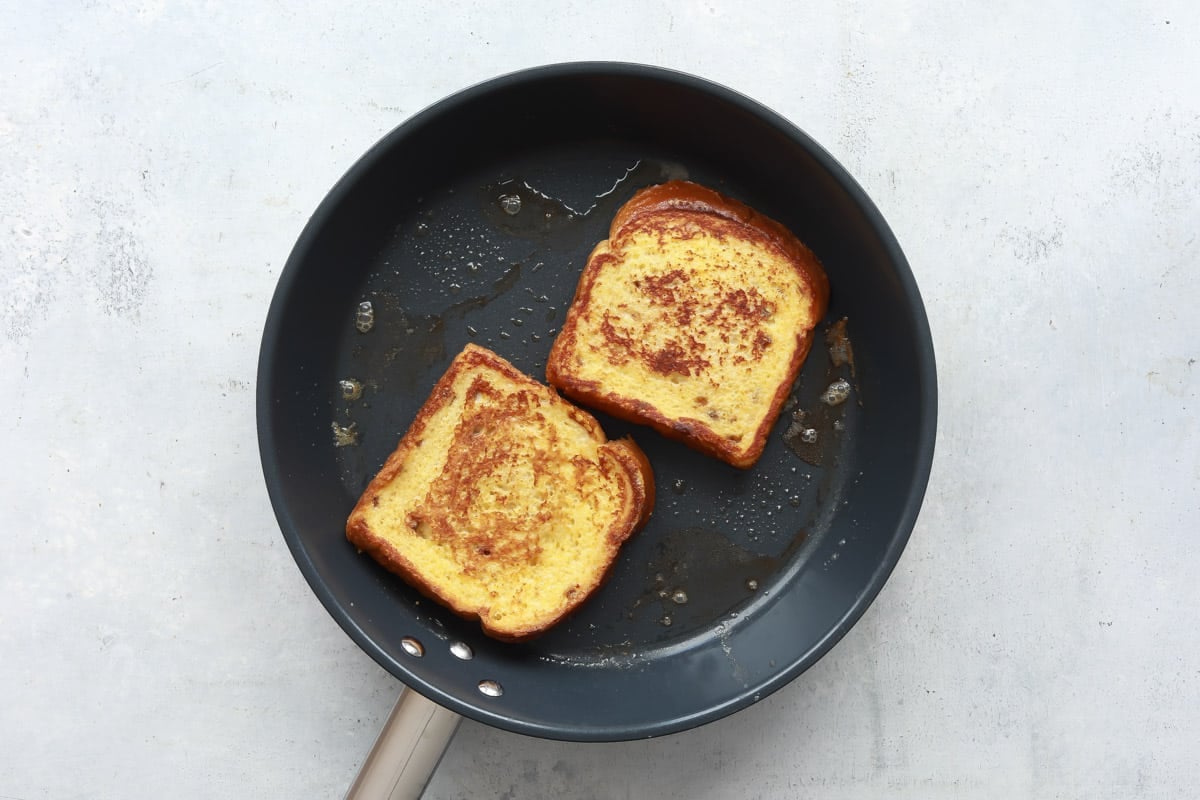 A skillet with French toast browning in it.