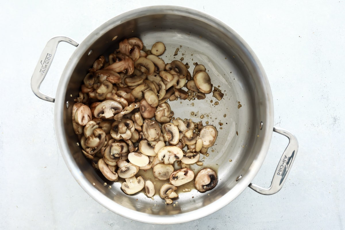 A pot full of cooked mushrooms.