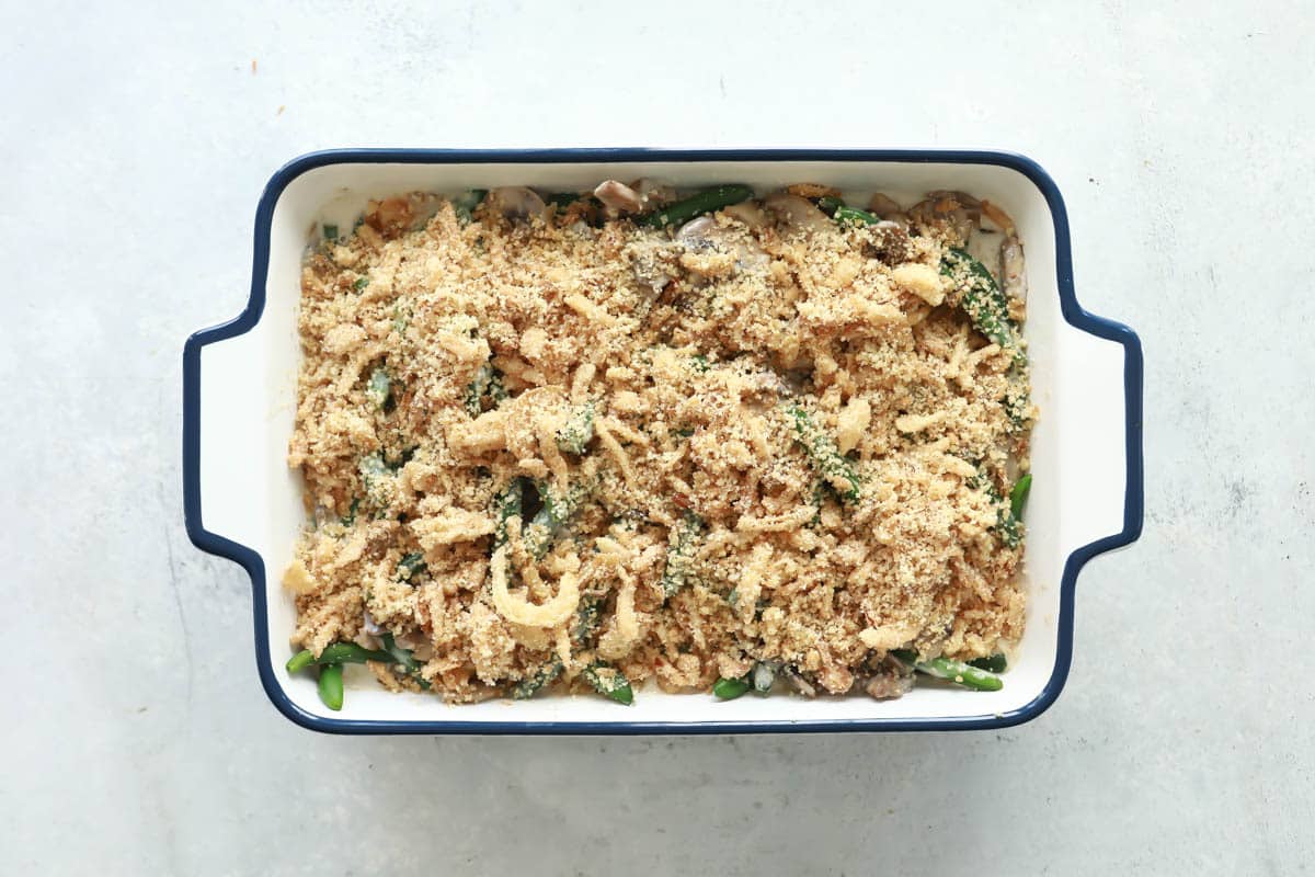 A casserole dish full of unbaked green bean casserole.