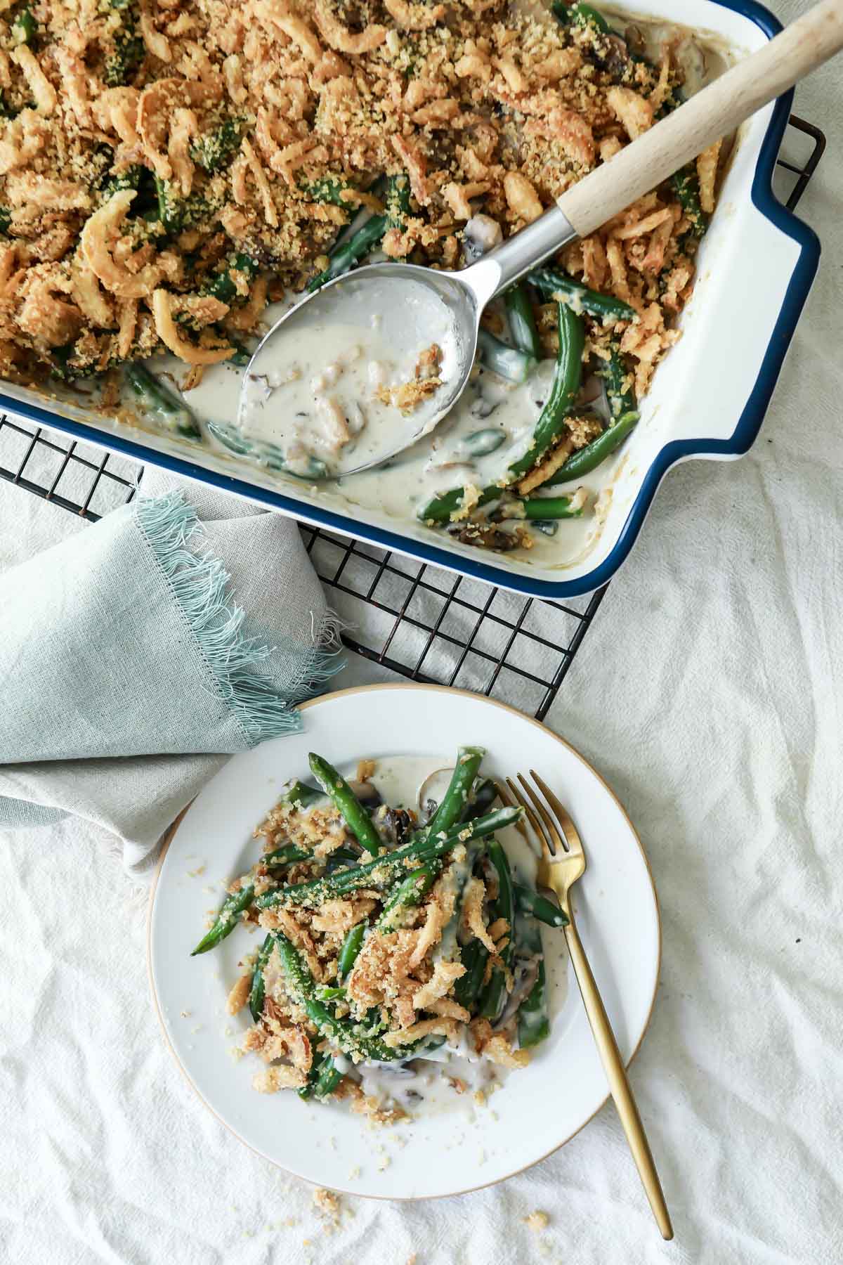 A casserole dish and a plate full of green bean casserole.