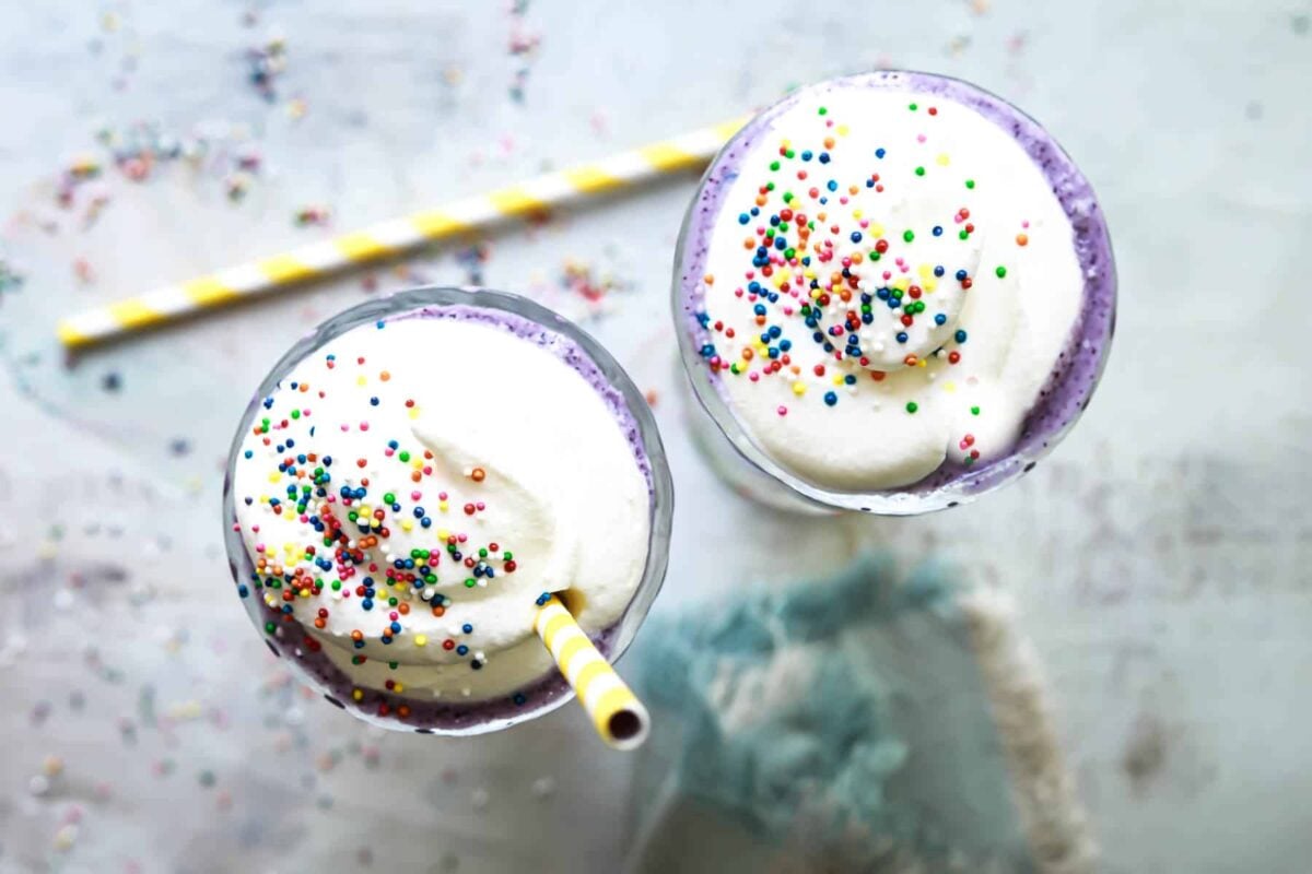 Two Grimace shakes on a counterop.