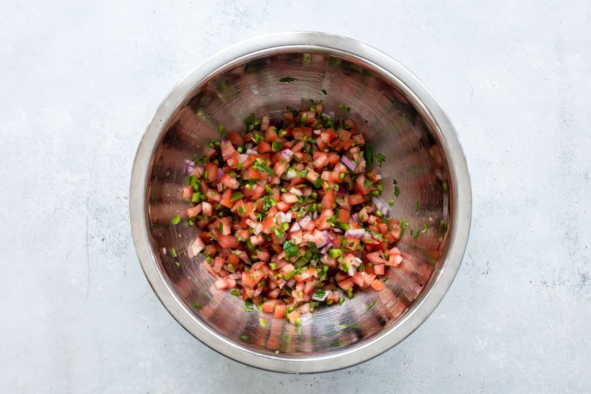Pico de gallo in a mixing bowl.
