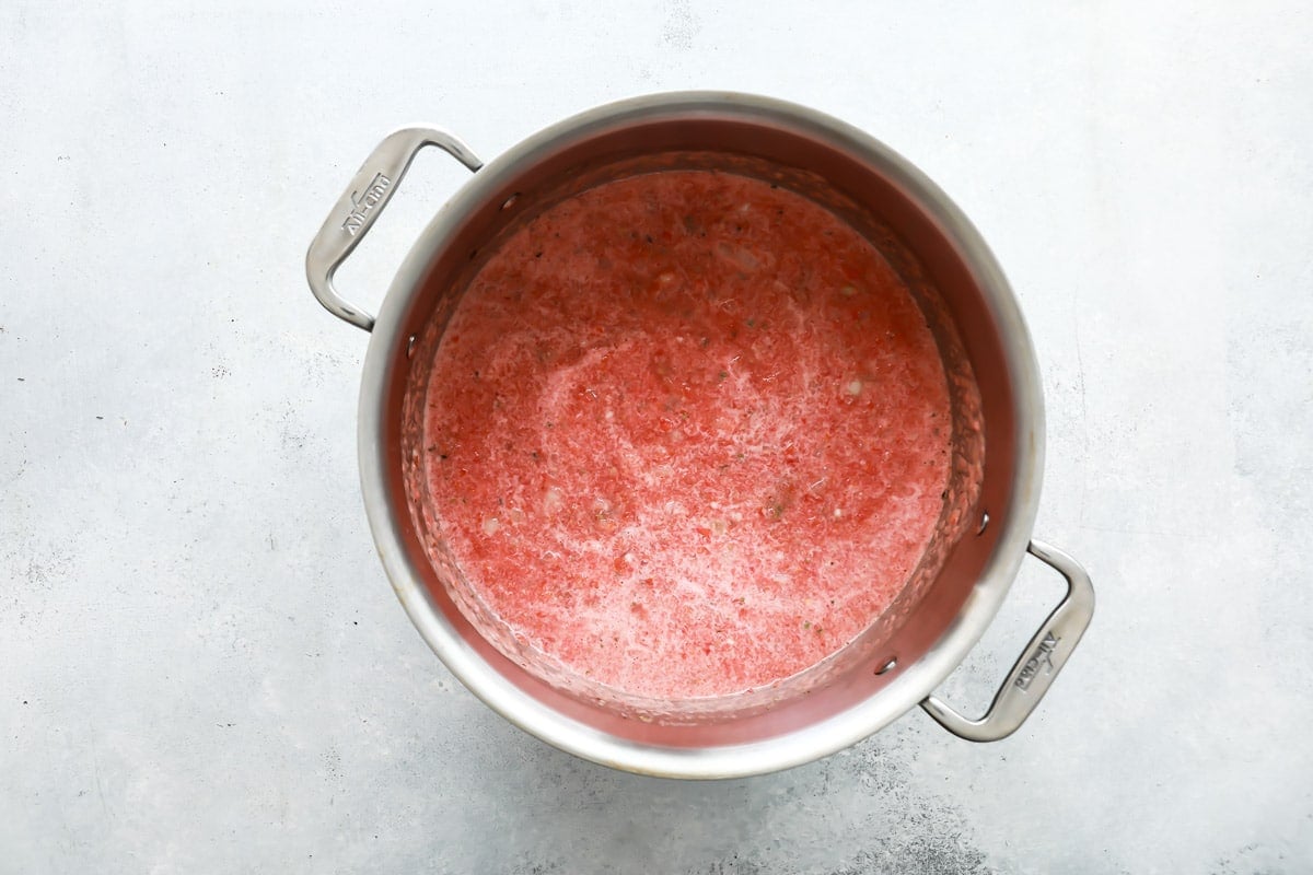 A stock pot full of fresh blended tomatoes.