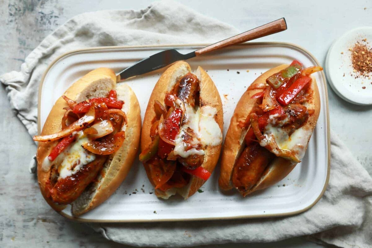 A platter of sausage and pepper sandwiches.