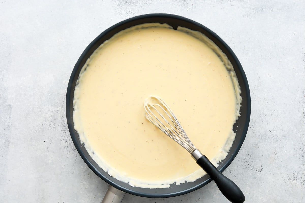A skillet full of homemade cheese sauce.