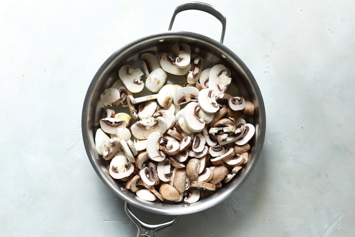 A saucepan full of mushrooms for vegan mushroom gravy.