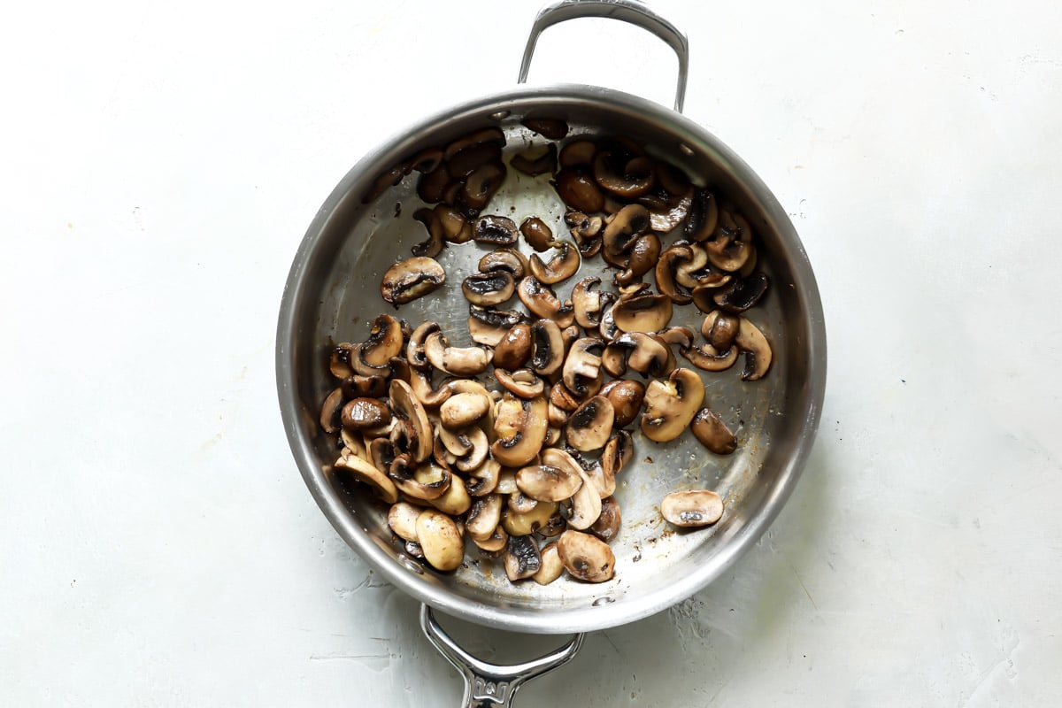 A saucepan full of mushrooms for vegan mushroom gravy.