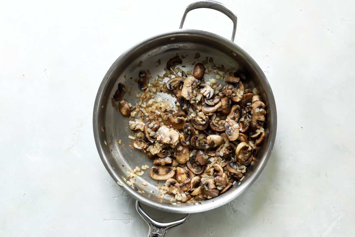 A saucepan full of mushrooms for vegan mushroom gravy.