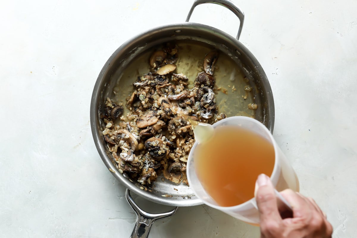 Making vegan mushroom gravy in a saucepan.