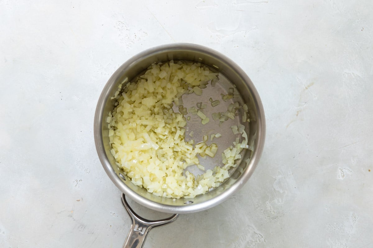 Onions cooking in a saucepan.