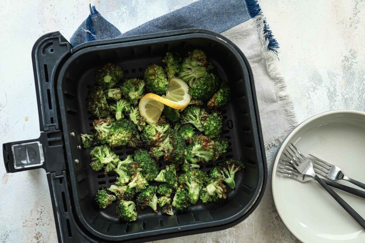 Air fryer broccoli in an air fryer basket.
