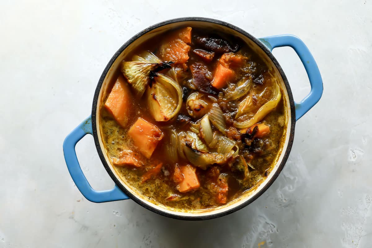 dutch oven with chicken broth and roasted butternut squash, onions, and apples. 