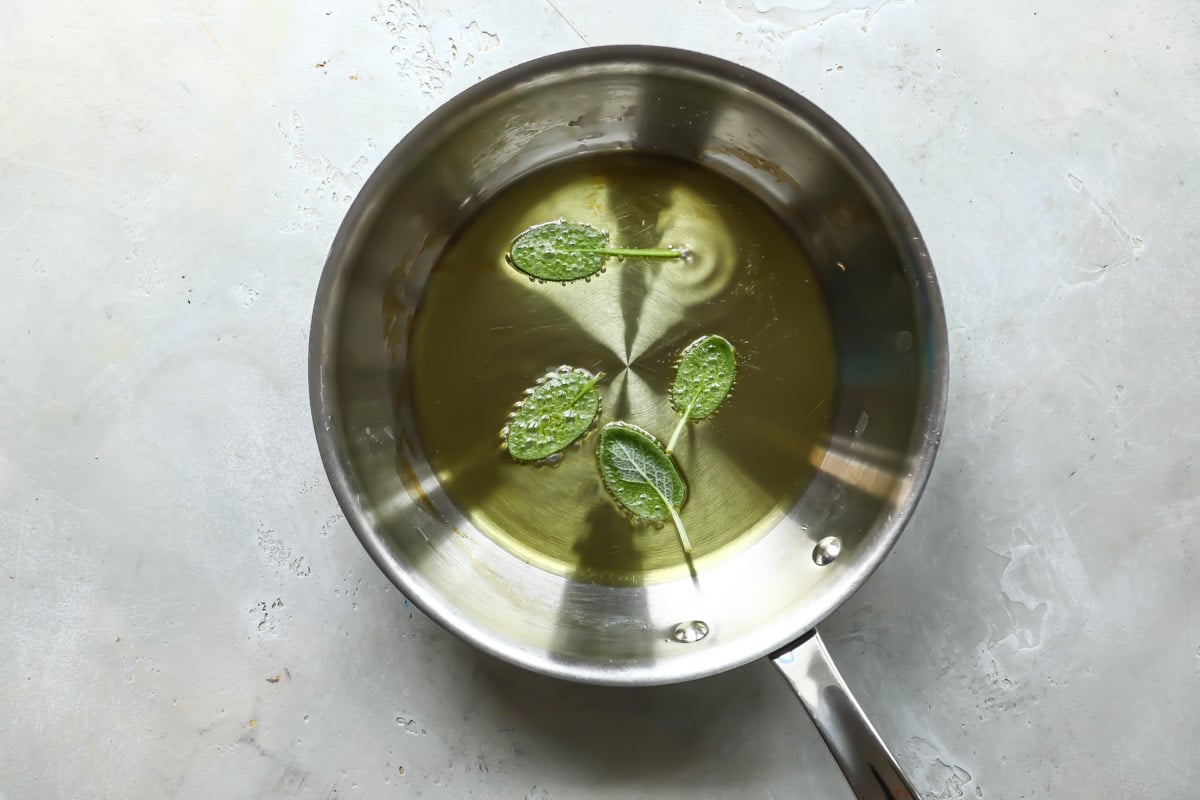 Frying sage leaves in a pan.