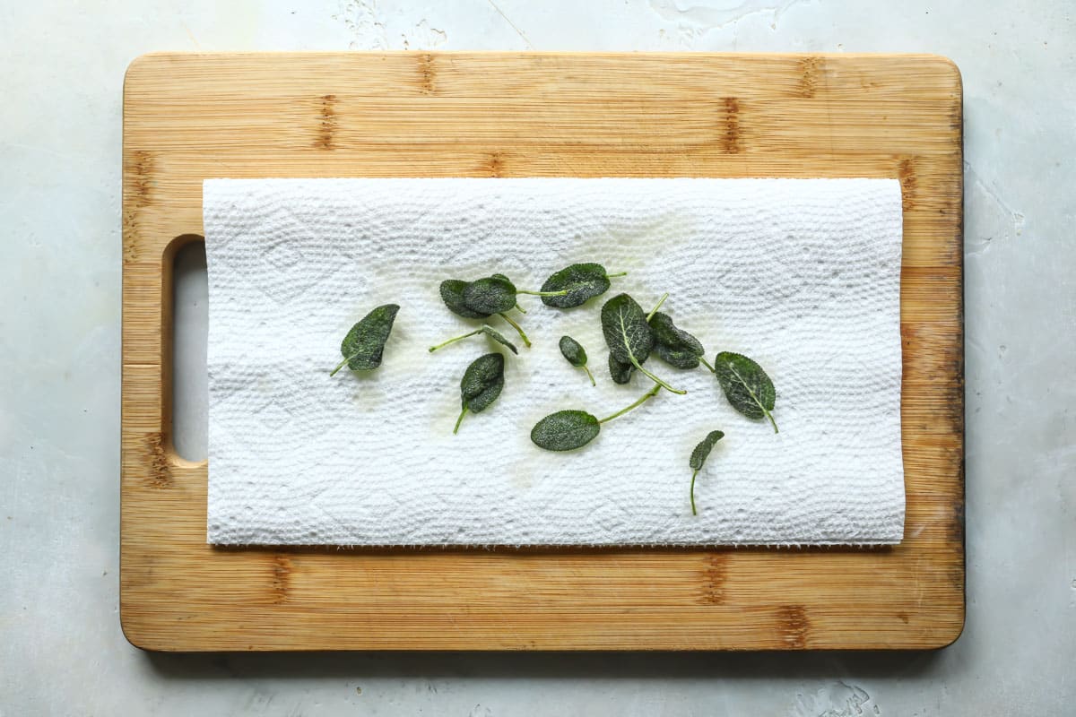 Sage leaves before being dried on a paper towel.