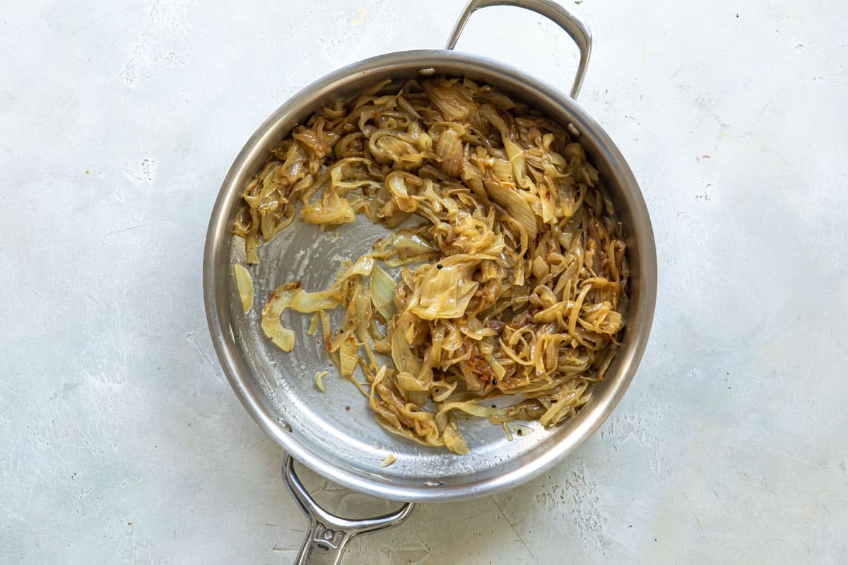 Caramelized onions in a silver skillet.