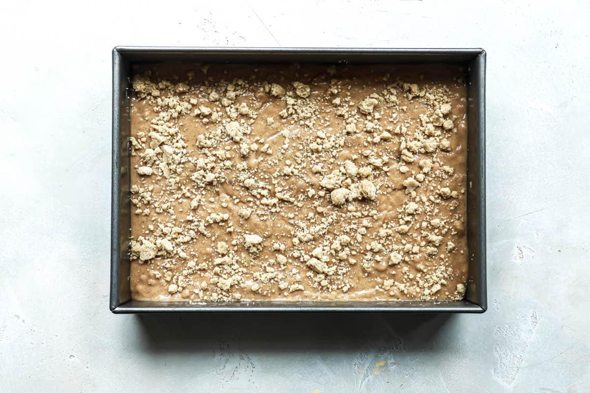 Cake batter for coffee cake in a pan before being baked.