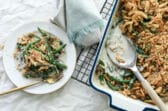 A casserole dish and a plate full of green bean casserole.