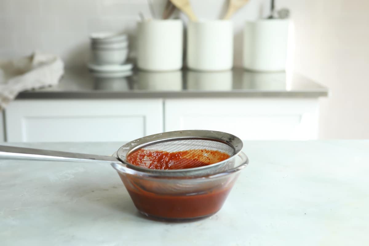 Chile sauce for Pozole Rojo being strained.