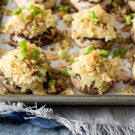 A baking sheet full of stuffed mushrooms.