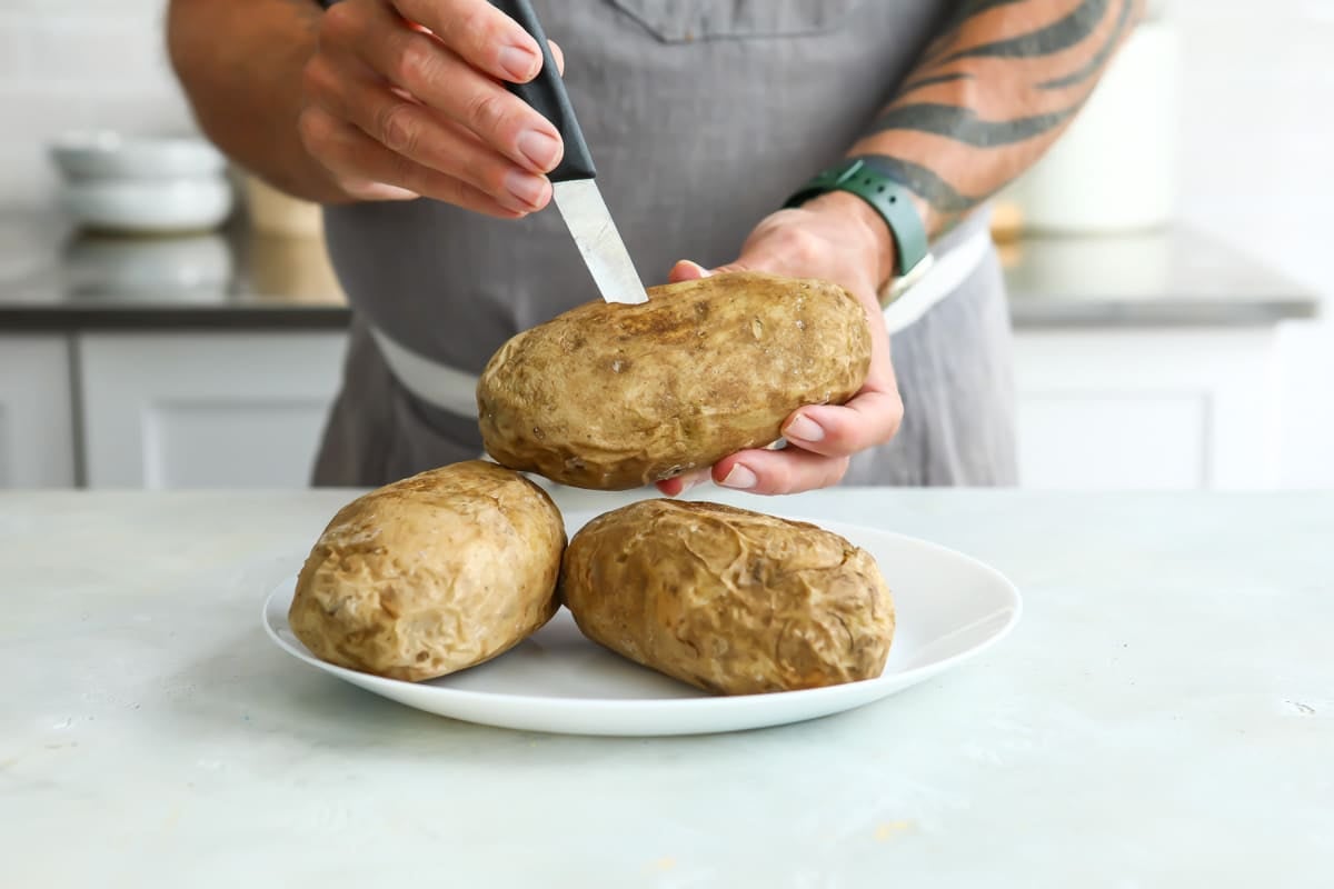 Poking a potato with a knife.