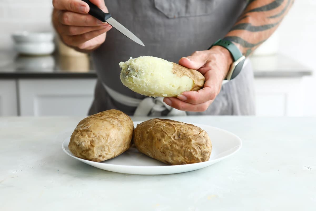 Poking a potato with a knife.
