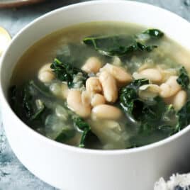 White bean and kale soup in a bowl.
