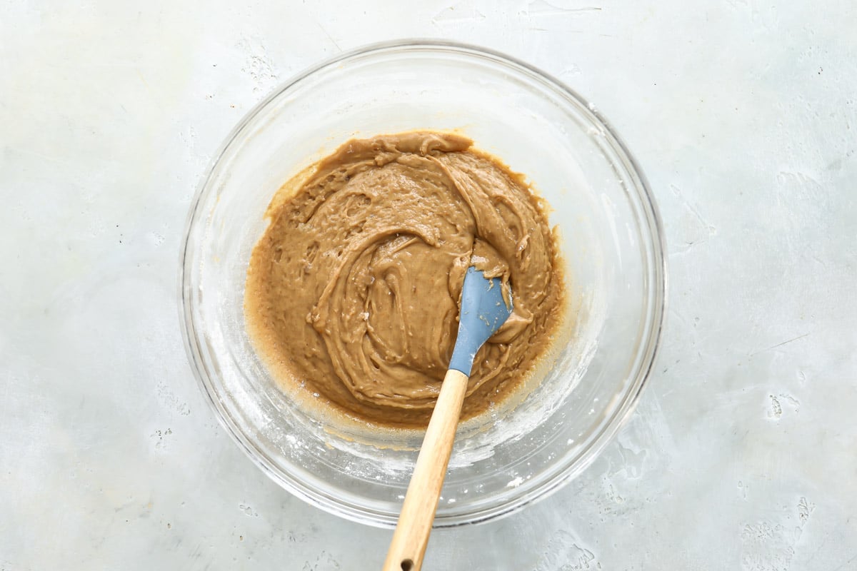 Zucchini bread batter in a clear bowl before zucchini has been added.