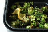 Air fryer broccoli in an air fryer basket.