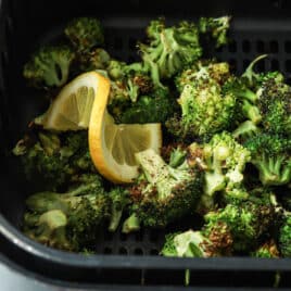 Air fryer broccoli in an air fryer basket.