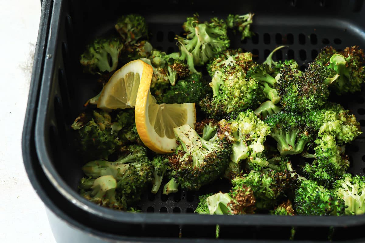 Air fryer broccoli in an air fryer basket.