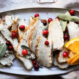 Slices of air fryer turkey on an oval platter.