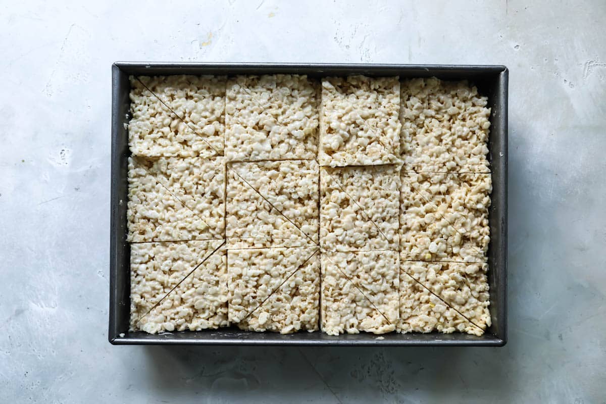 A pan of rice krispie treats cut in triangles.