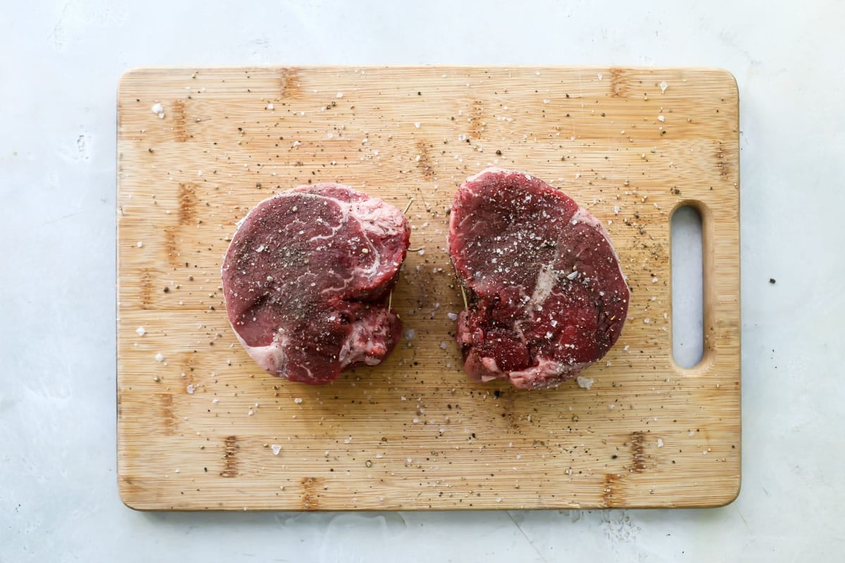 Two filets on a wooden cutting board.