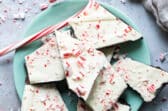 Peppermint bark on a teal plate.