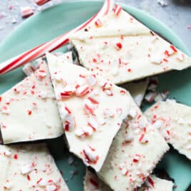 Peppermint bark on a teal plate.