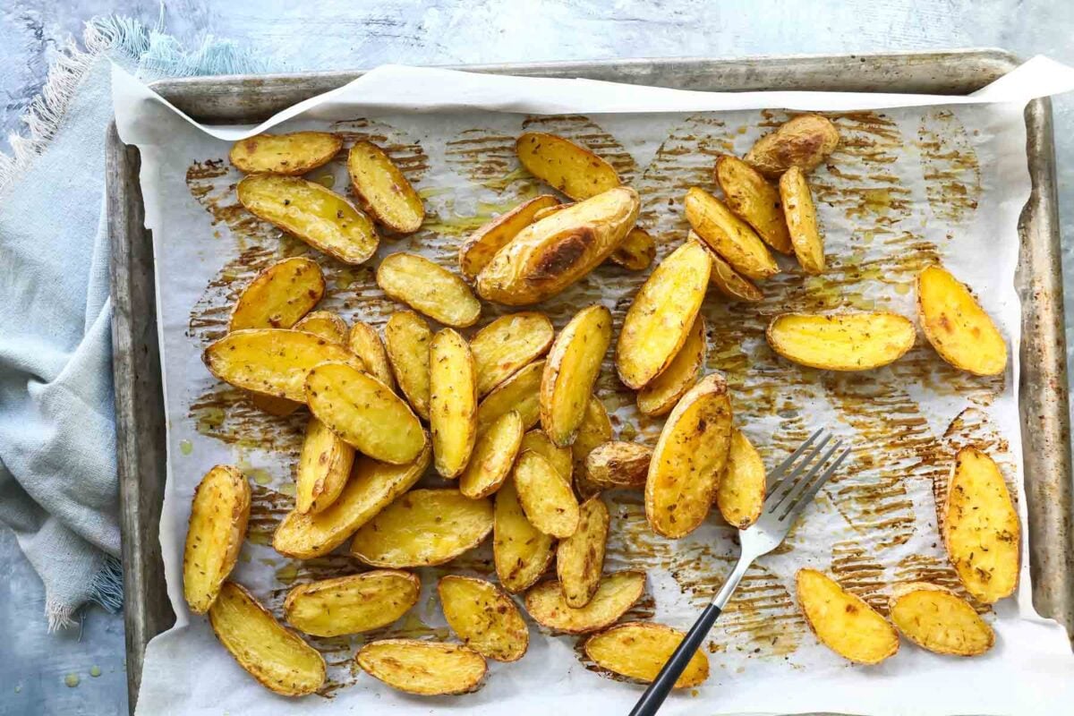 Roasted fingerling potatoes on a baking sheet.
