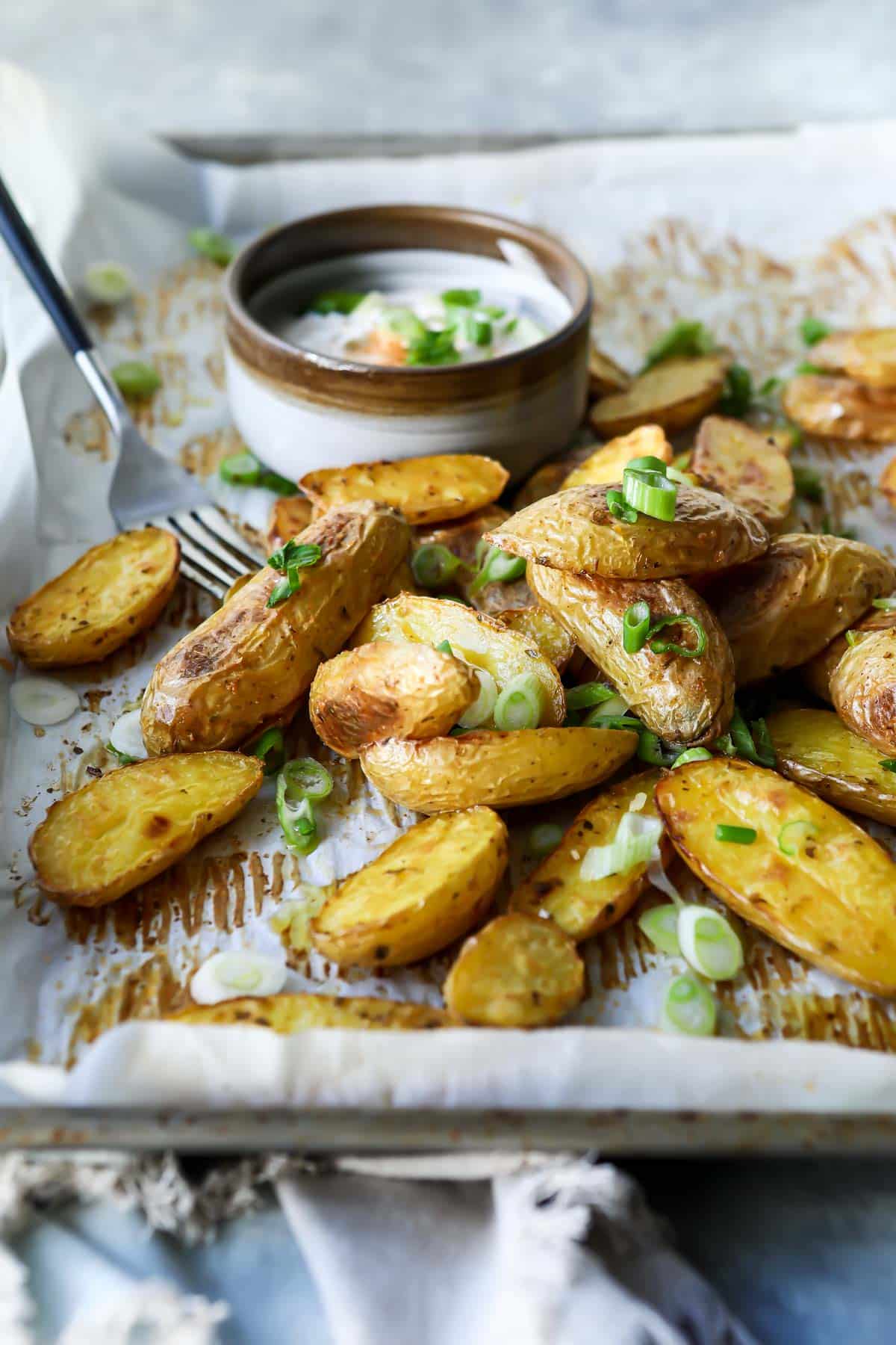 Roasted fingerling potatoes on a baking sheet.