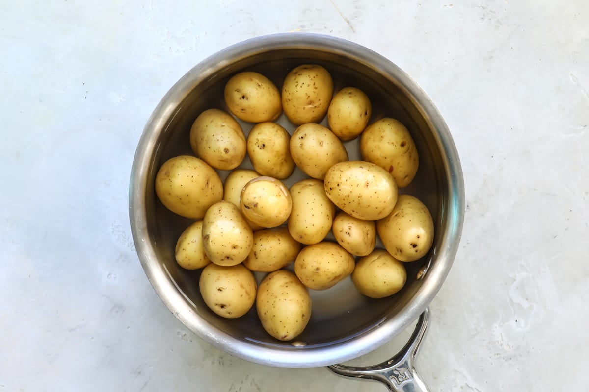 Baby Yukon gold potatoes in a silver pot.